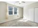Bedroom with bright window, a closet, neutral carpet and walls and a ceiling fan at 7535 Meridale Forest Dr # 107, Charlotte, NC 28269