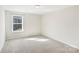 Bright bedroom with natural light and neutral carpeting at 7535 Meridale Forest Dr # 107, Charlotte, NC 28269