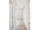 Bright hallway features neutral walls, carpet, and a curtained window at the end of the hall at 7535 Meridale Forest Dr # 107, Charlotte, NC 28269