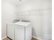Functional laundry room with modern machines, overhead shelving for storage, and neutral walls at 7535 Meridale Forest Dr # 107, Charlotte, NC 28269