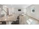 Open-concept space showcases kitchen island, living room furniture, neutral walls, wood floors and a flat screen TV at 7535 Meridale Forest Dr # 107, Charlotte, NC 28269