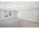 Main bedroom features a ceiling fan and natural light at 7535 Meridale Forest Dr # 107, Charlotte, NC 28269