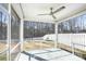 Screened patio looks out on a fenced yard with woods in the background and has a ceiling fan at 7535 Meridale Forest Dr # 107, Charlotte, NC 28269
