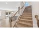 Elegant staircase leading to the upper level, with an open view of the kitchen area at 7535 Meridale Forest Dr # 107, Charlotte, NC 28269