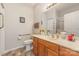 Well-lit bathroom featuring a wooden vanity, accessible grab bars, and a clean, functional layout at 864 Ledgestone Ct, Tega Cay, SC 29708