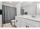 Bathroom with double sinks, white cabinets, a shower with a patterned curtain, and a toilet at 9203 Mackinaw Dr, Gastonia, NC 28056