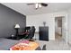 Cozy bedroom featuring a dark accent wall, modern desk, ample closet space, and neutral carpet at 9203 Mackinaw Dr, Gastonia, NC 28056
