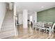 Open dining space with seating for eight, adjacent to staircase and desk area at 9203 Mackinaw Dr, Gastonia, NC 28056