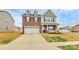 Attractive two-story home with brick and siding, front porch, and attached two-car garage at 9203 Mackinaw Dr, Gastonia, NC 28056