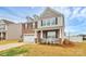 Beautiful two-story house with brick and siding, a cozy front porch, and a two-car garage at 9203 Mackinaw Dr, Gastonia, NC 28056