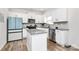 Modern kitchen with white cabinets, stainless steel appliances, and a granite-topped island at 9203 Mackinaw Dr, Gastonia, NC 28056