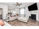 Cozy living room with fireplace, large window with modern curtains, and comfortable sofas and ottoman at 9203 Mackinaw Dr, Gastonia, NC 28056
