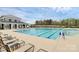 Relaxing community pool with lounge chairs and a nearby clubhouse in a scenic, wooded setting at 9203 Mackinaw Dr, Gastonia, NC 28056