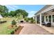 Backyard with a brick patio, fireplace, and lush landscaping at 1039 Rabbit Hill Ln, Monroe, NC 28110