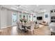 Dining room with hardwood floors, large windows, modern chandelier, and a view to the living room at 1039 Rabbit Hill Ln, Monroe, NC 28110