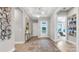 Stylish entryway with an area rug, decorative wall art, tray ceiling, and light hardwood floors at 1039 Rabbit Hill Ln, Monroe, NC 28110