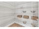 Walk-in pantry featuring white wire shelving and wood floors, providing ample storage space at 1039 Rabbit Hill Ln, Monroe, NC 28110