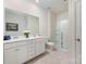 Bright bathroom featuring a double vanity, a large mirror, and a glass-enclosed shower at 1051 Lookout Shoals Dr, Fort Mill, SC 29715