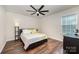 This bedroom has wood floors and a large window at 1051 Lookout Shoals Dr, Fort Mill, SC 29715