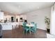 Bright dining area with white table, colorful chairs, and a view into a modern white kitchen at 1051 Lookout Shoals Dr, Fort Mill, SC 29715