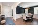 Beautiful dining room featuring a black accent wall, wood floors and modern chandelier at 1051 Lookout Shoals Dr, Fort Mill, SC 29715