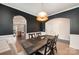 Elegant dining room with black accent wall, modern lighting, and hardwood floors at 1051 Lookout Shoals Dr, Fort Mill, SC 29715