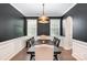 Sophisticated dining room featuring black accent wall, modern lighting, and hardwood floors at 1051 Lookout Shoals Dr, Fort Mill, SC 29715