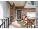 Charming front porch featuring a bistro set, brick siding and a welcoming 'hello' doormat at 1051 Lookout Shoals Dr, Fort Mill, SC 29715