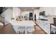 Stylish kitchen with white cabinets, stainless steel appliances, and hardwood floors at 1051 Lookout Shoals Dr, Fort Mill, SC 29715