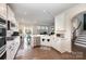 Bright kitchen with white cabinets, stainless steel appliances, and an open view to living area at 1051 Lookout Shoals Dr, Fort Mill, SC 29715