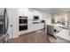 Modern kitchen with stainless steel appliances, quartz counters, and sleek white cabinetry at 1051 Lookout Shoals Dr, Fort Mill, SC 29715