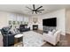 Spacious living room featuring a fireplace, a large television, and plush seating arrangements at 1051 Lookout Shoals Dr, Fort Mill, SC 29715