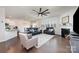 Stylish living room boasts a fireplace, dark-wood flooring, and comfortable seating with lots of natural light at 1051 Lookout Shoals Dr, Fort Mill, SC 29715