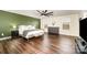 This spacious main bedroom has wood floors and a large window at 1051 Lookout Shoals Dr, Fort Mill, SC 29715