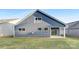 Backyard featuring a blue home with a covered patio and a grassy lawn at 111 Noah Ln, Troutman, NC 28166