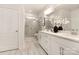 Elegant bathroom with dual sinks, white cabinetry, a glass-enclosed shower, and decorative floral arrangement at 111 Noah Ln, Troutman, NC 28166