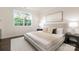 Bright bedroom with a large window, neutral decor, and a comfortable-looking bed with stylish throw pillows and blanket at 111 Noah Ln, Troutman, NC 28166