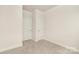 Cozy bedroom with two doors, neutral carpet, and white trim at 111 Noah Ln, Troutman, NC 28166