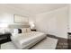 Well-lit bedroom featuring a stylish bed, complementing end tables, and modern art for a comfortable, inviting space at 111 Noah Ln, Troutman, NC 28166