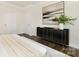 Nicely decorated bedroom with contemporary art and dark cabinet with gold accents; light and airy design at 111 Noah Ln, Troutman, NC 28166