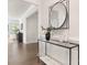 Inviting hallway with a decorative mirror, console table, and view into the living area, showcasing modern design at 111 Noah Ln, Troutman, NC 28166