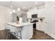 Well-lit kitchen features stainless steel appliances, a central island with barstool seating, and ample storage at 111 Noah Ln, Troutman, NC 28166