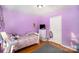 A cute bedroom with purple walls, light hardwood flooring, and small dresser at 114 Yates St, Dallas, NC 28034