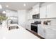 Bright kitchen featuring white cabinets, stainless steel appliances, and quartz countertops at 115 Noah Ln, Troutman, NC 28166