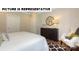 Bedroom featuring white bedding, dark wood floors, and a black dresser at 117 Noah Ln, Troutman, NC 28166