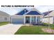 Charming home featuring a well-maintained lawn, a grey two-car garage, and a welcoming front porch at 117 Noah Ln, Troutman, NC 28166