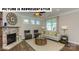 Inviting living room with a stone fireplace, comfortable seating, and bright windows at 117 Noah Ln, Troutman, NC 28166