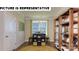 Bright office space with natural light, decorative shelving, and a cozy rug at 117 Noah Ln, Troutman, NC 28166