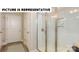 Walk-in shower featuring white subway tile, glass doors and a built in soap nook at 117 Noah Ln, Troutman, NC 28166