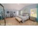 This primary bedroom features soft blue walls, carpet flooring, and lots of natural light at 128 Rustling Waters Dr, Mooresville, NC 28117